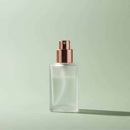 Sage Green setting spray in frosted glass bottle with rose gold nozzle on sage background